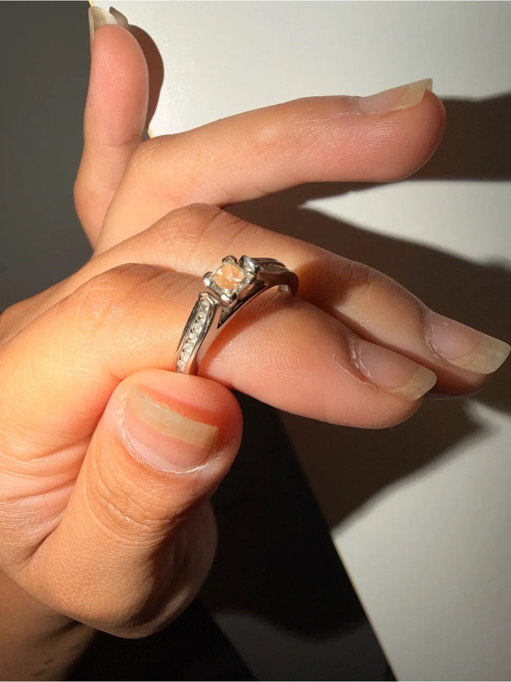 14k white gold with a 1 carat diamond princess cut ring.